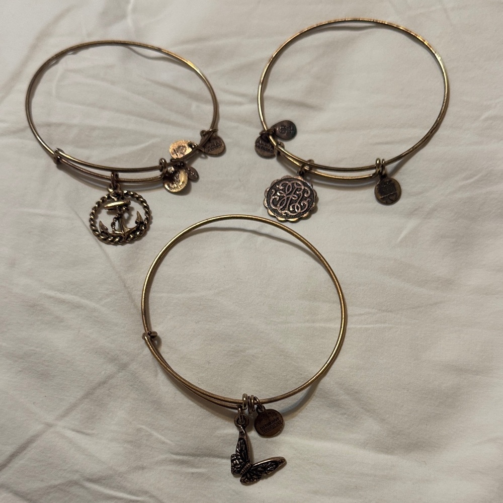 Three Alex and Ani Elegant Golden tone Charm Bracelets.